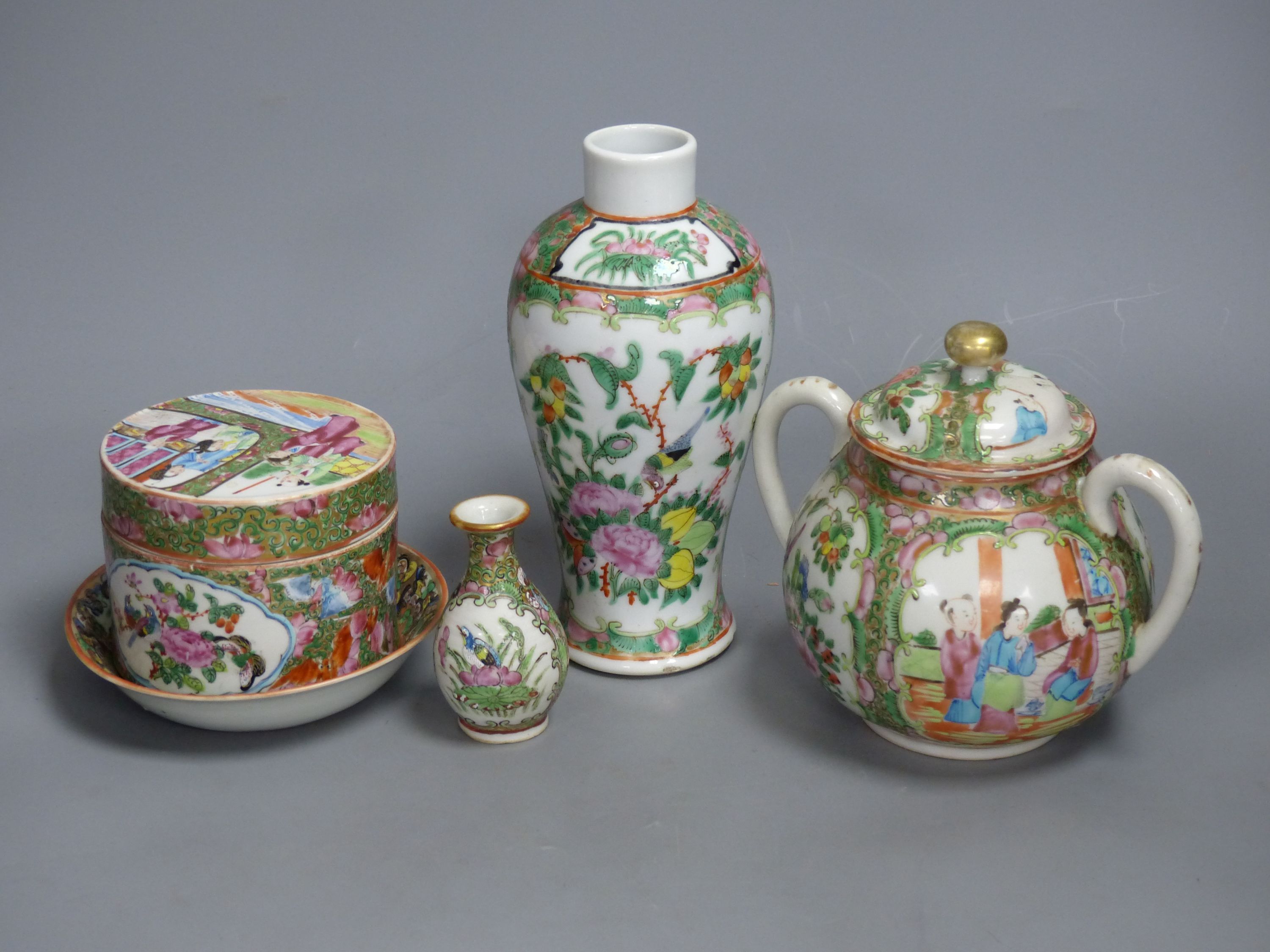 A Chinese famille rose box and cover, two vases, a sugar bowl and cover and a saucer, late 19th/early 20th century, tallest 19cm